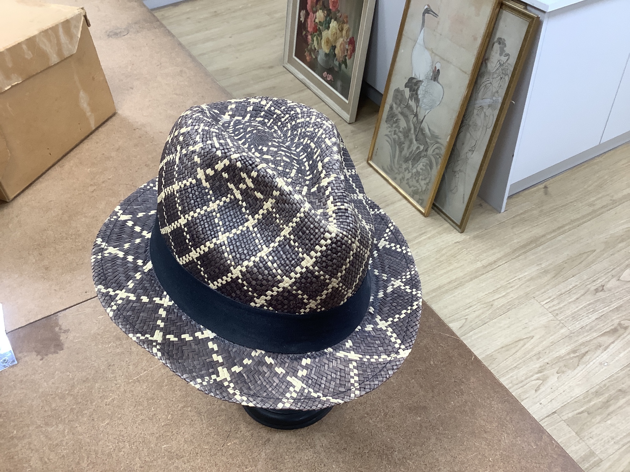 A Moroccan Fez and a Panama hat in a Dunn & Co hat box together with a hat stand